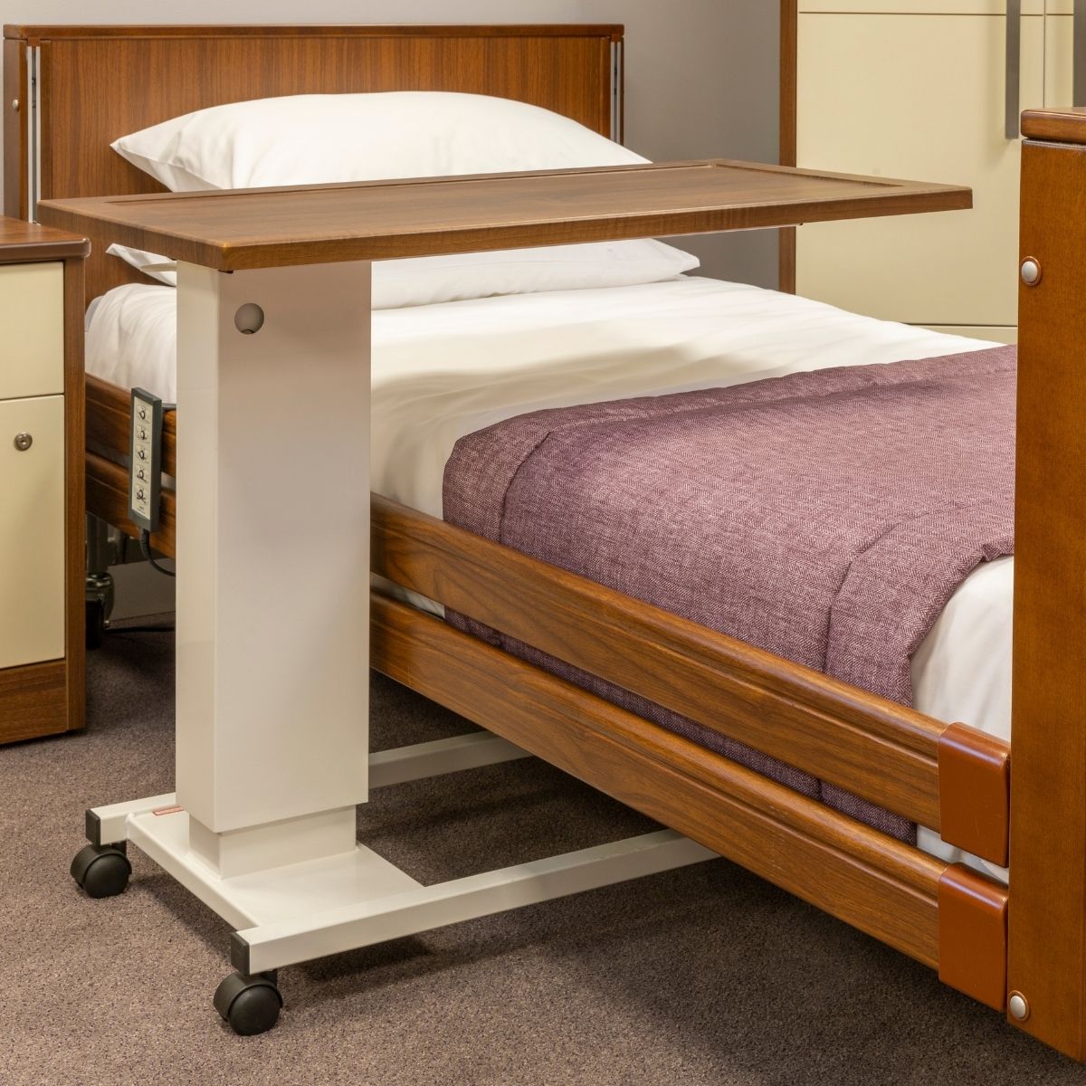 profiling care bed and over bed table in walnut